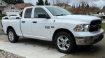 White Dodge Ram 1500 4x4 in excellent condition, showcasing chrome wheels and pristine exterior.