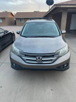 Front view of a 2013 Honda CR-V EX FWD SUV in grey, parked in a residential area.