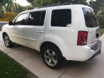 White 2013 Honda Pilot EX-L SUV parked with spacious interior for 8, excellent condition, low mileage.