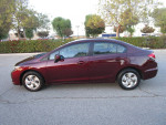 Side view of a well-kept 2014 Honda Civic LX Sedan in maroon color with clean title and 94k miles.