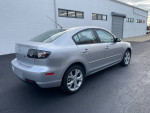 Silver Mazda 3 parked, featuring low mileage of 102,000 miles and a clean exterior.