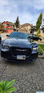 Front view of a 2016 Chrysler 300S in black, showcasing sleek design and alloy wheels.