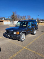 1999 Land Rover Discovery parked in an outdoor lot, showcasing its reliable design and condition.