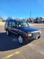 1999 Land Rover Discovery parked in an open area, showcasing its rugged design and reliability.
