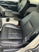 Interior view of a 2016 Dodge Grand Caravan Crew Plus with black leather seats.