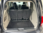 Interior view of 2016 Dodge Grand Caravan Crew Plus with rear seats folded down and spacious trunk.