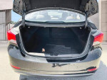 Open trunk of a 2013 Hyundai Elantra showcasing ample storage space for cars and trucks.