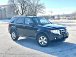 2010 Ford Escape in black with 92,000 miles, well-maintained and clean, ready for sale.