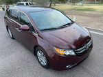 2016 burgundy Honda Odyssey SE minivan with 95,000 miles, automatic transmission, and spacious interior.