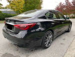2018 Infiniti Q50 Red Sport 400 AWD luxury sedan with alloy rims and panoramic sunroof, parked outdoors.