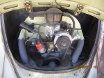 Engine compartment of a vintage 1963 Volkswagen Bug with a patina paint job