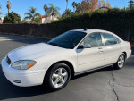 2004 Ford Taurus SES in white with 120k miles, clean title, parked in a sunny location.