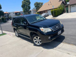 2010 Lexus GX 460 4WD in black parked on the street, featuring clean lines and original paint.
