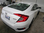 2016 Honda Civic Touring FWD parked in garage, displaying sleek design and well-maintained condition.
