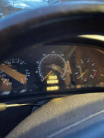 Dashboard view of a 1997 Mercedes-Benz SL500 showing mileage and temperature.