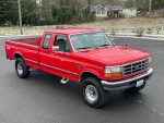 1997 Ford F250 truck with 7.3 Powerstroke engine, red color, on display in a residential area