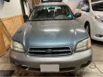 Front view of a 2002 Subaru Outback with low mileage, well-maintained and ready for new adventures.