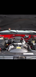Engine compartment of a 1999 Chevrolet Tahoe showcasing maintenance and condition details.