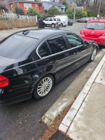 2007 BMW 335i twin turbo parked on the street with new tires and recent repairs visible.