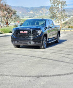 2022 GMC Sierra X31 SLT 4X4 truck with a diesel engine, parked on a sunny day in a scenic area.
