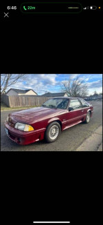 1990 Ford Mustang GT in great condition, featuring a sunroof and aftermarket upgrades, parked outside.