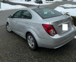 2012 Chevrolet Sonic in impeccable condition, parked on a snowy street.