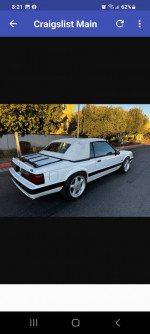 1989 Ford Mustang LX convertible with original body panels and modified springs parked on the street.