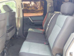 Rear interior view of a Nissan Titan 4x4 Crew Cab showing seating for six with power features.