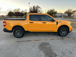 2023 Ford Maverick XLT in Cyber Metallic Orange parked, showcasing its sleek design and excellent condition.