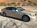 2007 Lexus LS 460 RWD in gold color, showcasing luxury features and elegant design, parked in a sunny location.