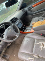 Interior view of a used 2002 Lexus ES 300 showing worn leather seats and dashboard details.
