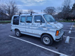 1992 Dodge Ram Van B250, well-maintained camper with a vintage look parked in a spacious lot.