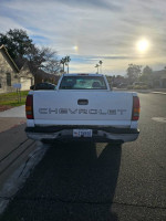 Rear view of a 2002 Chevrolet Silverado 1500 parked on a suburban street.