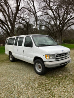 1997 Ford E-350 15-passenger van in white, low mileage, ideal for strong performance and potential.