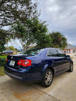 2006 Volkswagen Jetta TDI in Shadow Blue parked outdoors, showcasing its sleek design and modern features.
