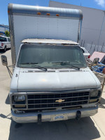 Front view of a used Chevy G30 Moving Van Box Truck for sale, displaying its mileage and condition.