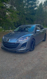 2011 Mazda 3 s Sport Hatchback in gray with custom black wheels parked in nature