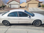 2002 Mercury Sable with new tires, showing minor scratches and parked in residential area.