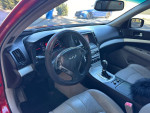 Interior view of a 2009 Infiniti G37 sedan showing dashboard, steering wheel, and gear shifter.