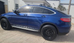 Stunning blue Mercedes GLC Coupe with black wheels, showcasing a lifted off-road design and premium features