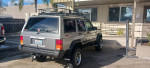 1993 Jeep Cherokee 4X4 in Gunmetal Gray with cargo rack parked outside
