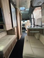 Interior view of a 2022 Airstream Interstate 19 RV with modern amenities and seating.