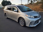 2020 Toyota Sienna XLE minivan in silver color, featuring a sleek design and alloy wheels.