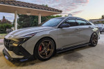 2023 Hyundai Elantra N in pristine condition with upgraded wheels and sporty design, parked outdoors.