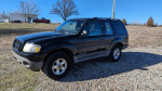 2001 Ford Explorer parked on gravel, showcases black color and off-road design, mileage, and overall condition.