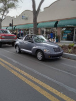 2007 Chrysler PT Cruiser Convertible parked on the street, showcasing its low mileage and classic design.