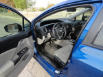 Interior view of a 2015 Honda Civic showing controls and spacious seating, very good condition.