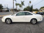 2000 Honda Accord EX-L in pearl white exterior, showcasing V6 engine and cream leather interior on a sunny street.