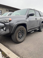 2023 Toyota 4Runner SR5 RWD in gray with off-road tires parked on pavement