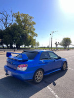 2007 Subaru Impreza STI in excellent condition, parked in a scenic area with clear blue sky.